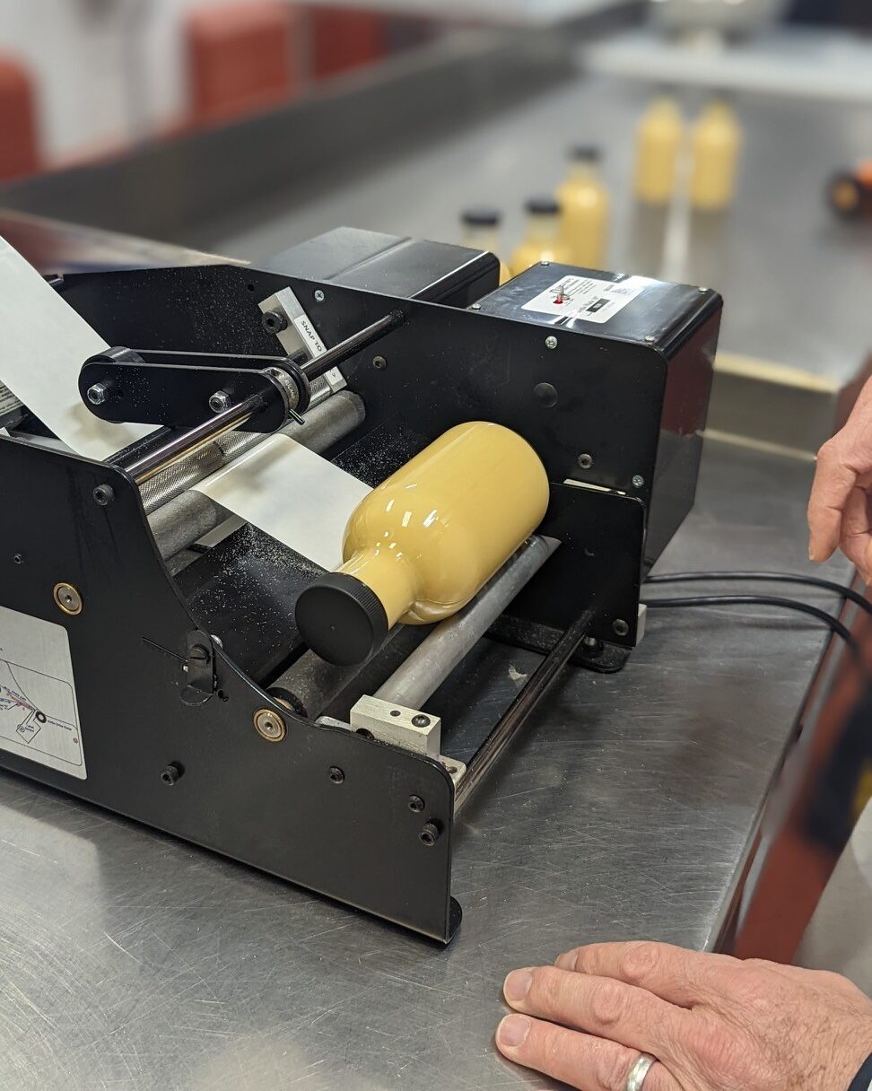 Bottle in label machine