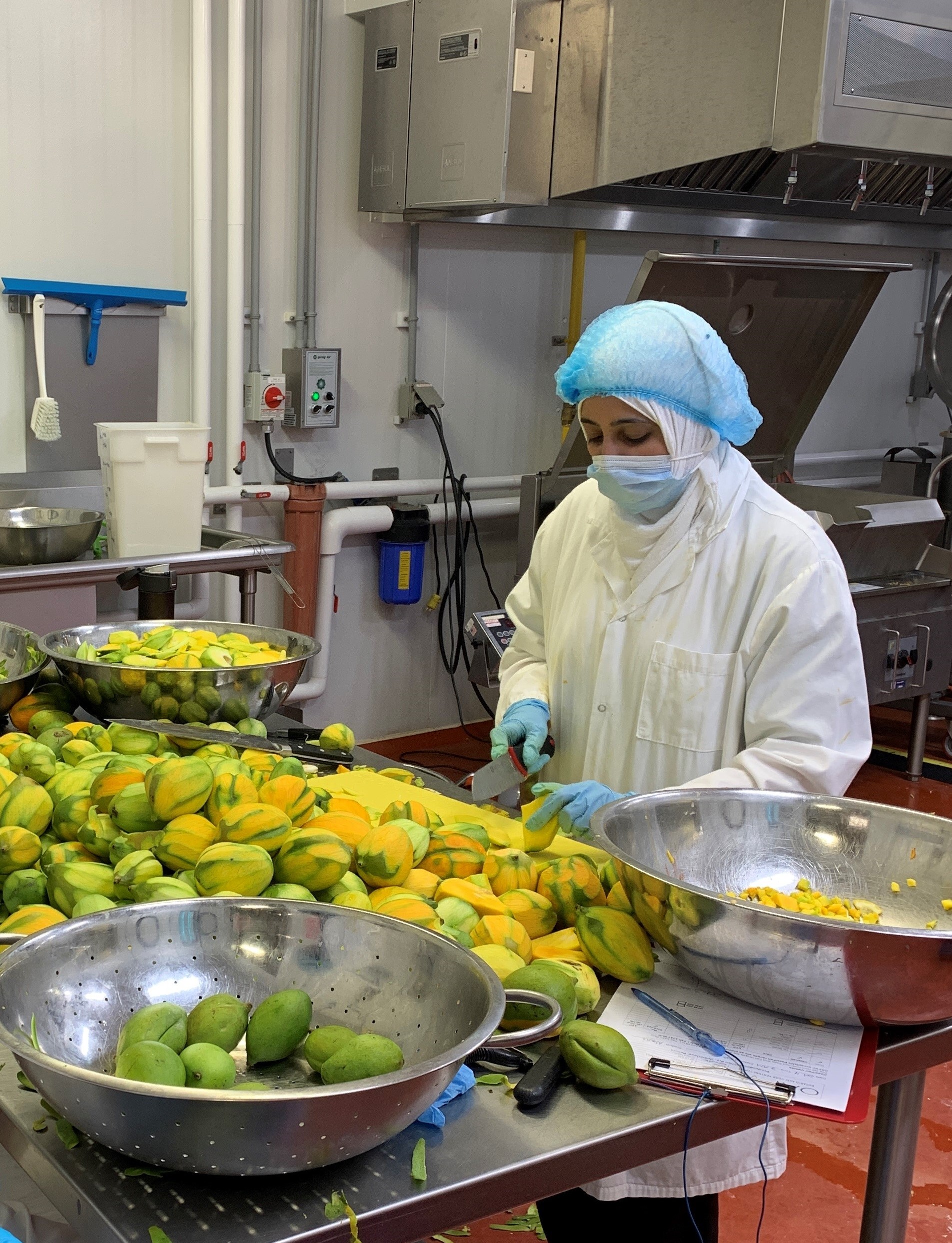 OAFVC client peels mangos